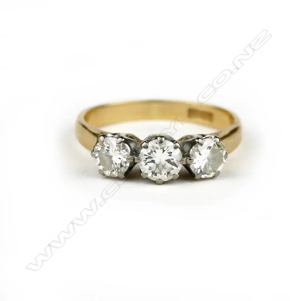 An 18ct. gold and three stone diamond ring Image 1++