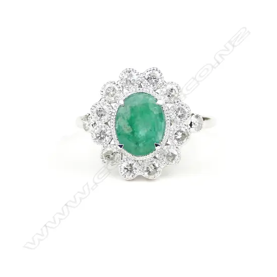 An 18ct. white gold emerald and diamond ring