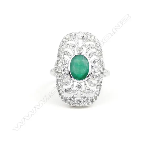 An 18ct. white gold emerald and diamond Art Deco style ring