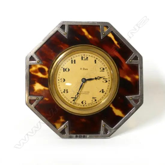 An Art Deco silver mounted tortoiseshell strut back desk clock