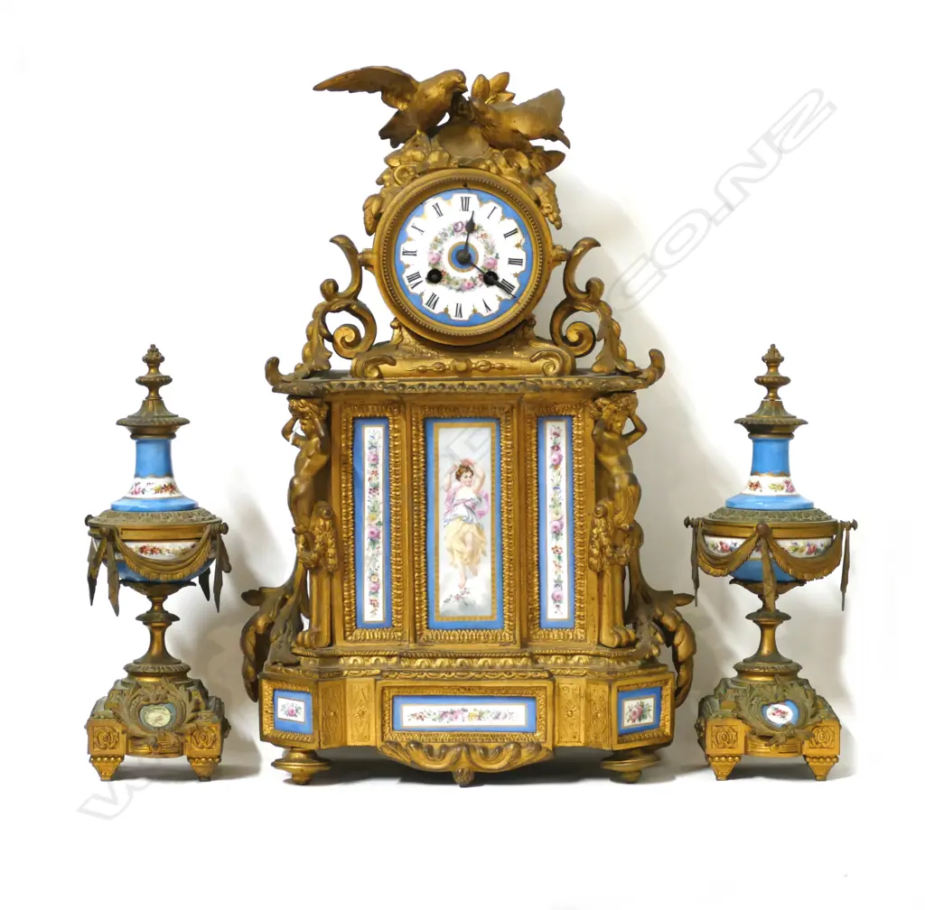 A French gilded and porcelain mantel clock with garnitures Image 1++