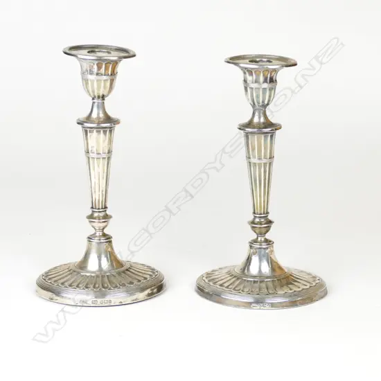 A pair of late Victorian silver candlesticks
