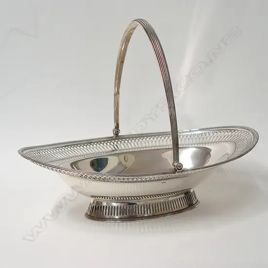 A George III impressive large silver swing handled basket