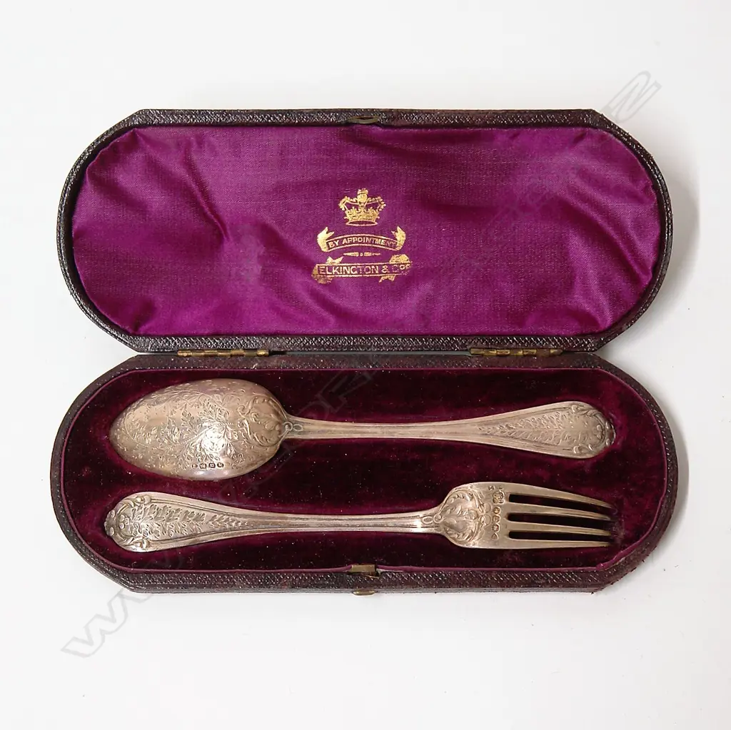 A cased pair of a Victorian silver christening spoon and fork set Image 1++