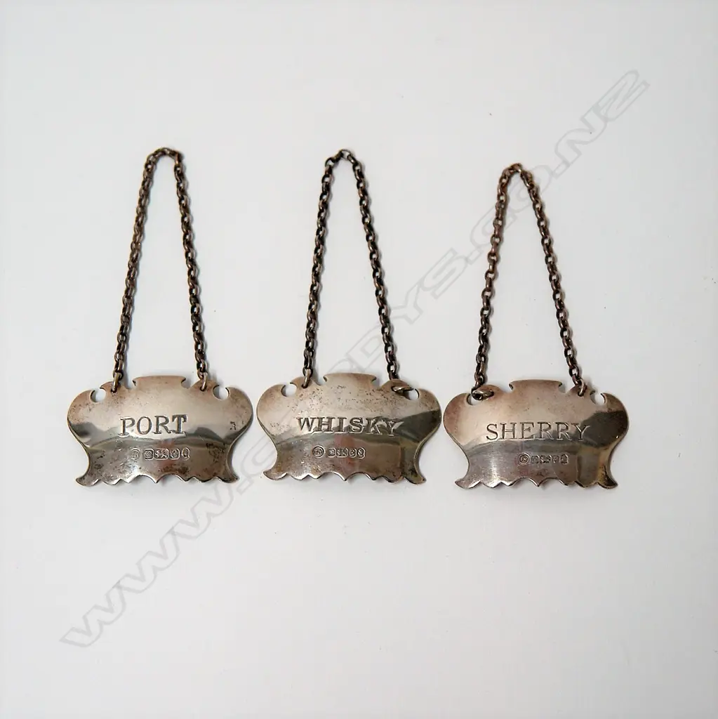 Three 20thC silver bottle tickets Image 1++