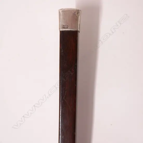 An antique dark stained beech walking cane of unusual tapering square section