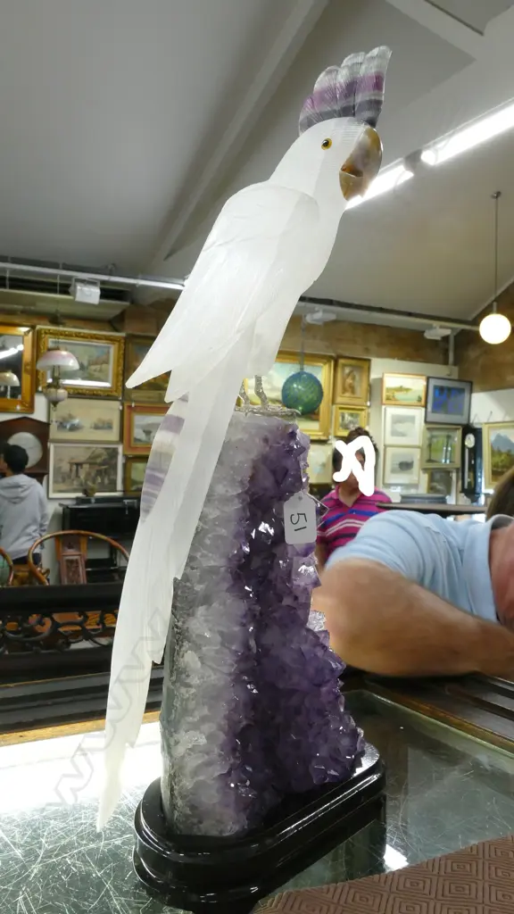 A sculpted alabaster parrot on amethyst geode base Image 1++