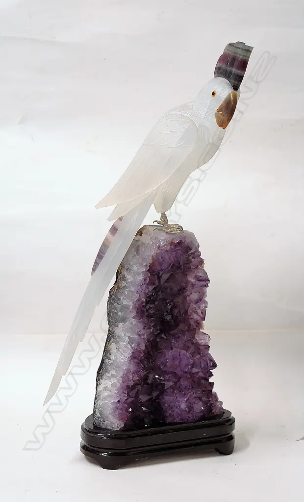 A sculpted alabaster parrot on amethyst geode base Image 1++