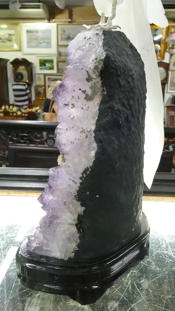 A sculpted alabaster parrot on amethyst geode base Image 1++