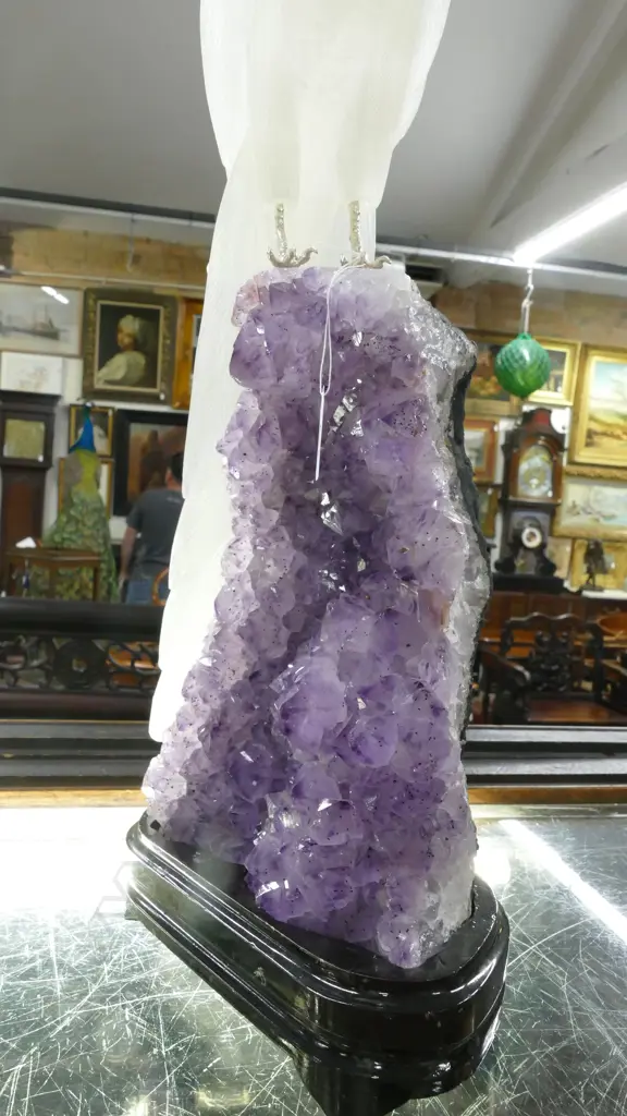 A sculpted alabaster parrot on amethyst geode base Image 1++