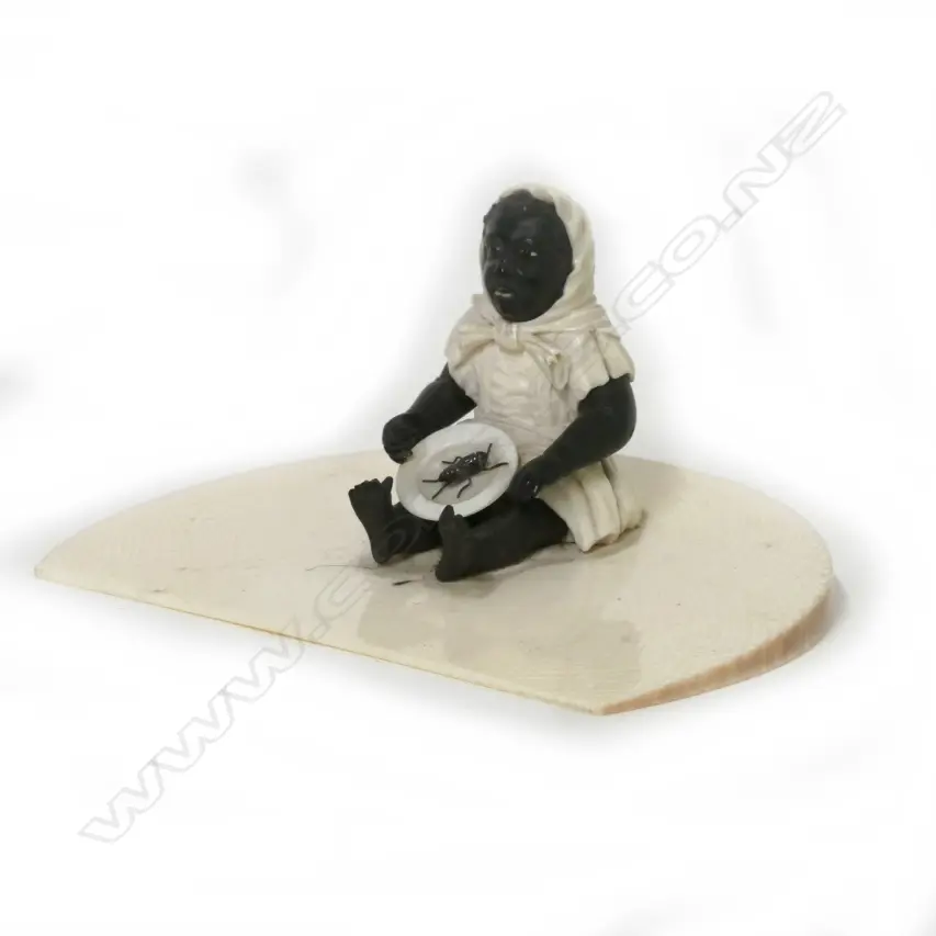 A small rare and collectable ivory and ebony figure of a black child with a plate and large spider Image 1++