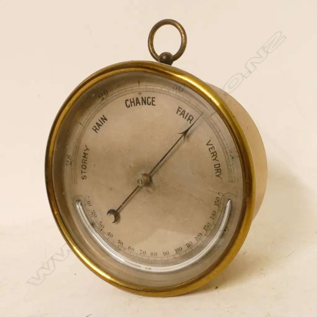 A brass cased aneroid barometer Image 1++