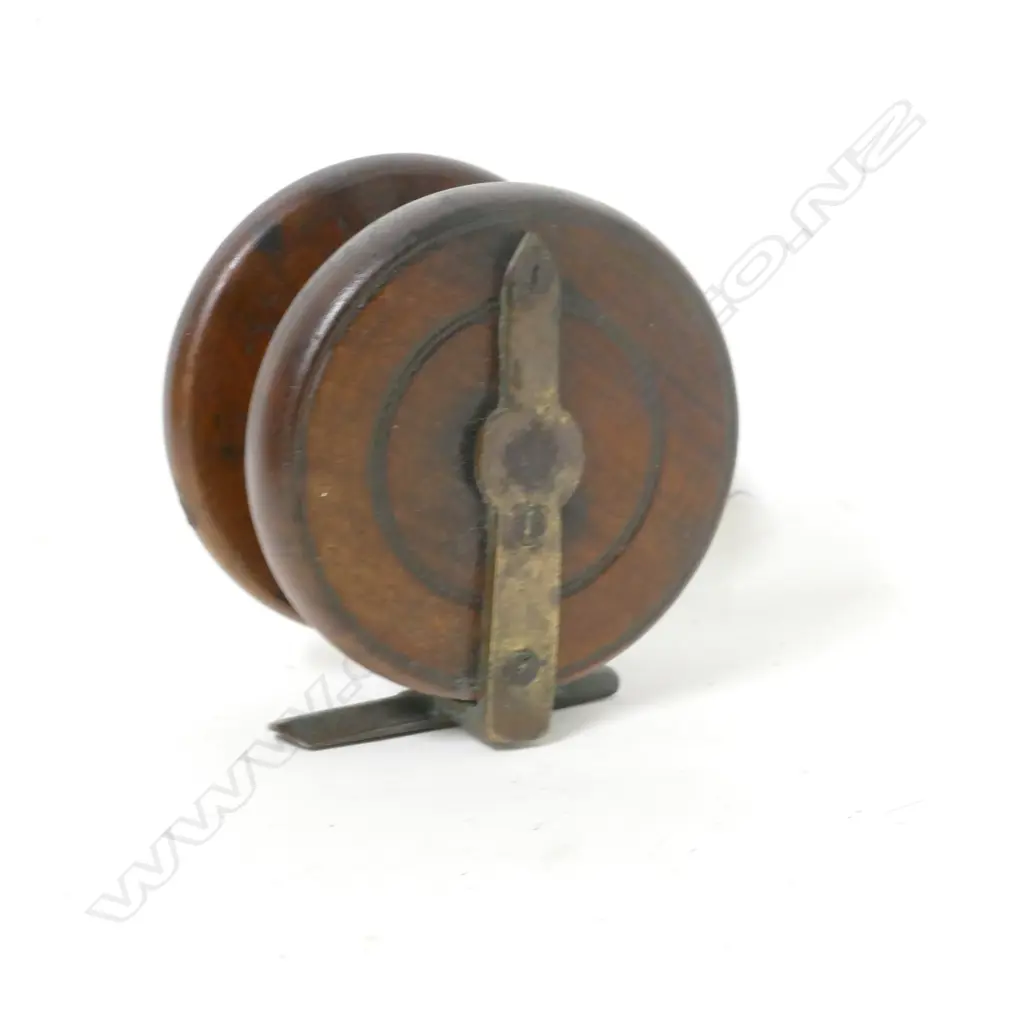 A 3" wooden reel with brass cathedral spire back Image 1++