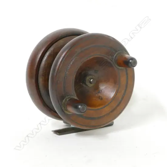 A 3" wooden reel with brass cathedral spire back