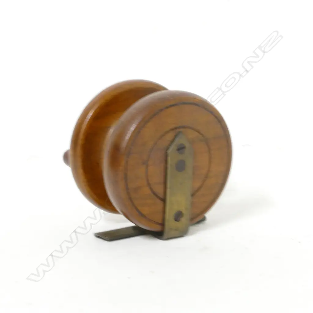 A 2⅝" walnut reel with brass cathedral spire back and reel seat Image 1++