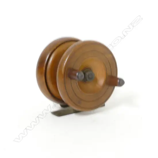 A 2⅝" walnut reel with brass cathedral spire back and reel seat