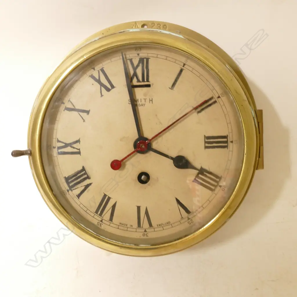 A brass and steel cased naval ship's clock Image 1++