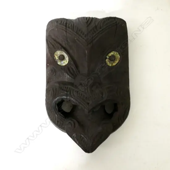 A decorative Maori wood mask carving