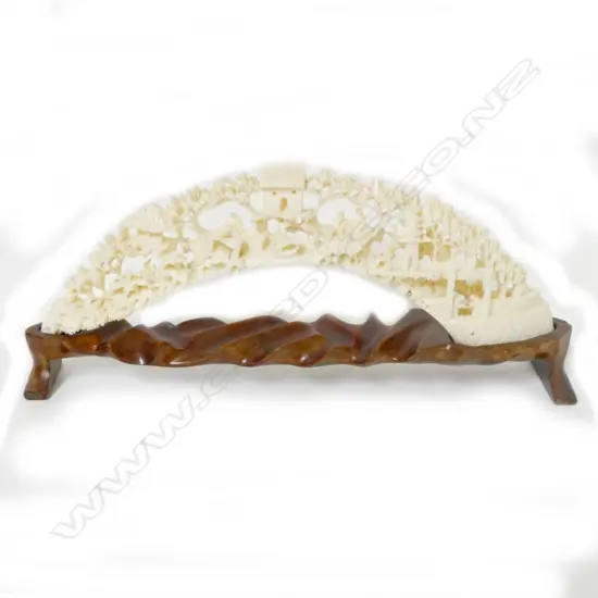 An ornately carved hippopotamus tusk