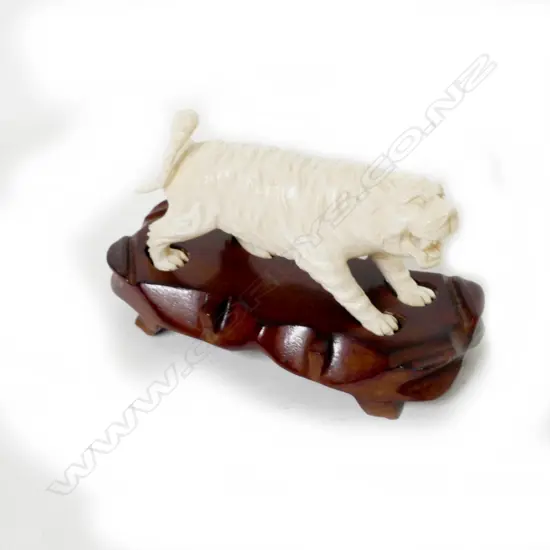 A carved ivory carving of a tiger