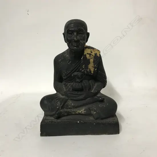A cast iron figure of a Thai monk