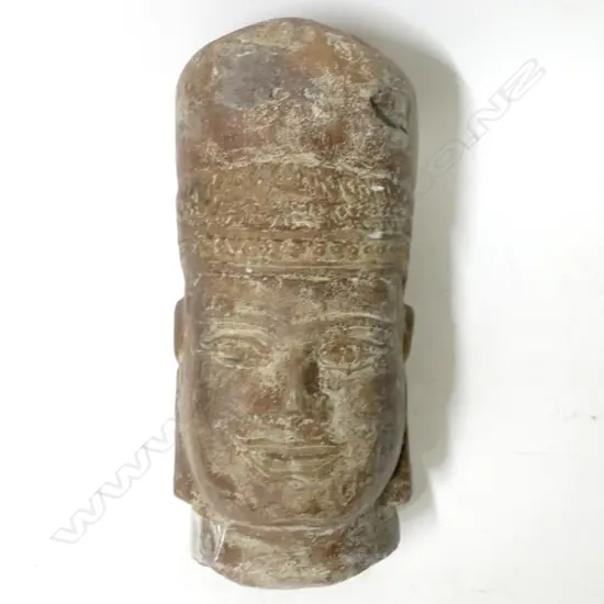 A stone head of a Khmer king