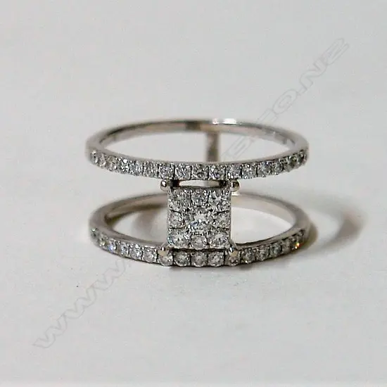 A lady's modern 14ct. white gold and diamond cluster and double band ring
