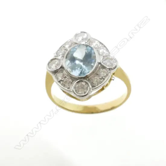 An Art Deco style 18ct. gold diamond and aquamarine ring