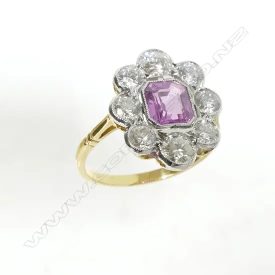 An Art Deco style 18ct. gold diamond and pink sapphire ring