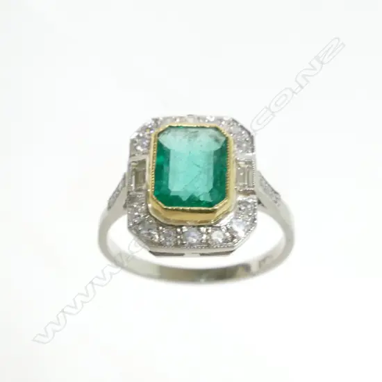 An Art Deco style platinum emerald and diamond ring
