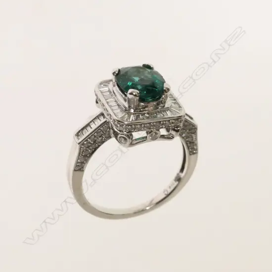 An Art Deco inspired bespoke made emerald and diamond cluster ring