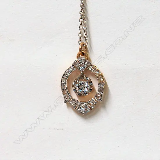 An estate 18ct. gold and platinum diamond pendant