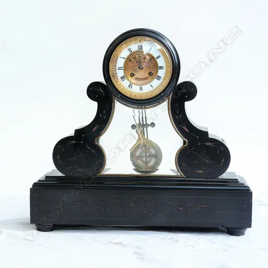 A Victorian black slate mantel clock