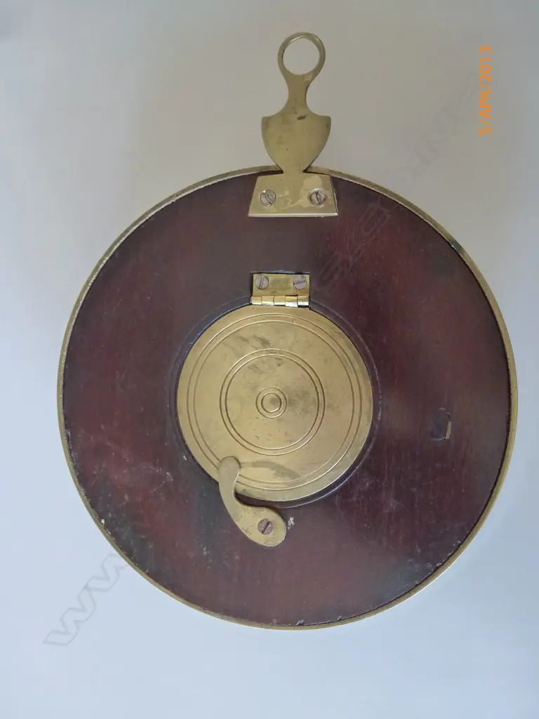 A sedan chair clock with circular turned mahogany case and traditional hanger and latched hinged back flap to permit rear winding with included key Image 1++