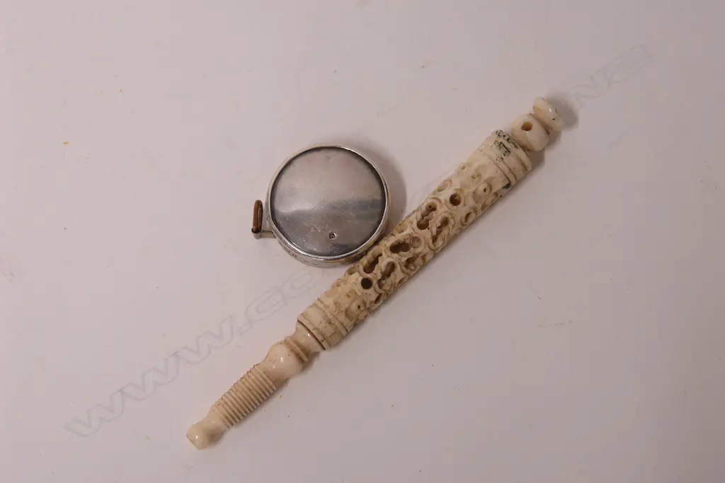 An Edwardian silver cased tape measure and carved bone needle case Image 1++