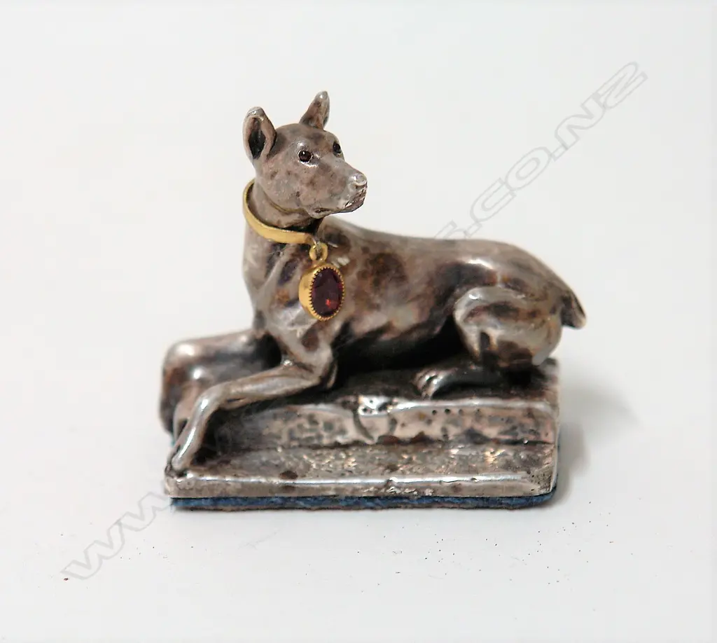 A modern silver recumbent dog paperweight Image 1++