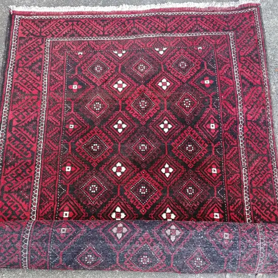 An unusually large hand knotted Baluchi tribal rug