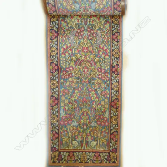 A narrow hand knotted Persian Kerman runner