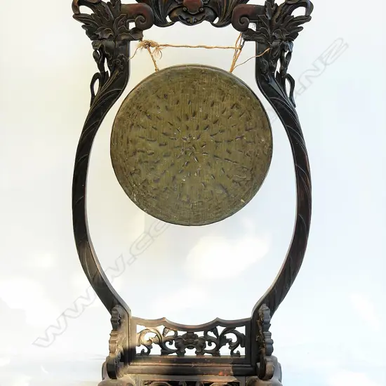 An old Oriental carved framed standing brass gong