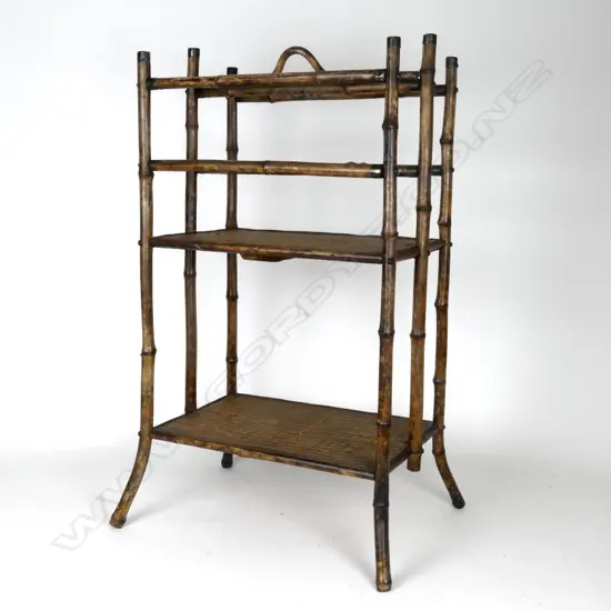 A Victorian mottled bamboo and rattan two-stage magazine rack