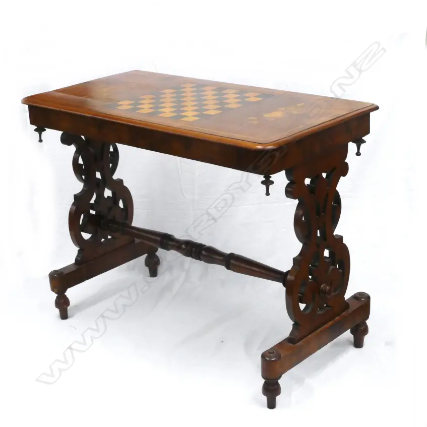A Victorian figured walnut games table of refectory style Image 1++