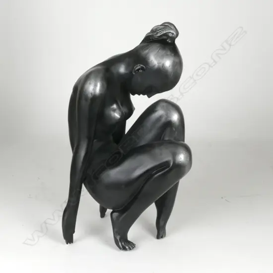 A white metal patinated sculpture of a naked woman