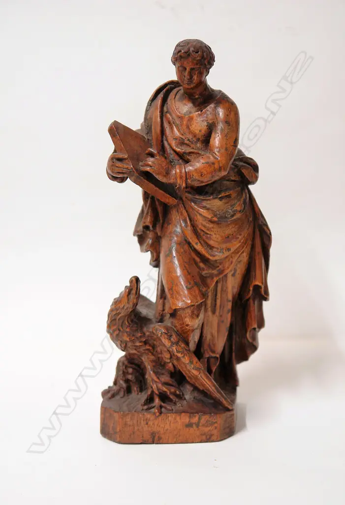 A 17thC French carved walnut statue of the evangelist St John Image 1++