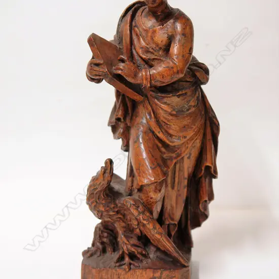 A 17thC French carved walnut statue of the evangelist St John