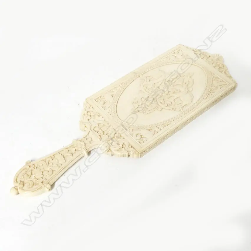 A carved Indian ivory hand mirror Image 1++