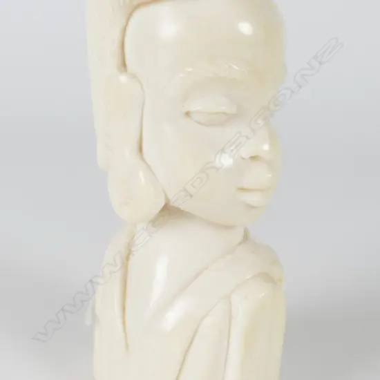 A small solid carved ivory bust of an African woman