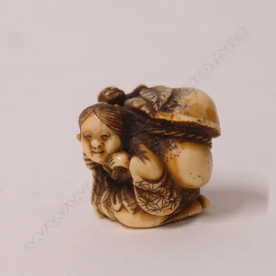 A fine old Japanese carved ivory netsuke of Okame