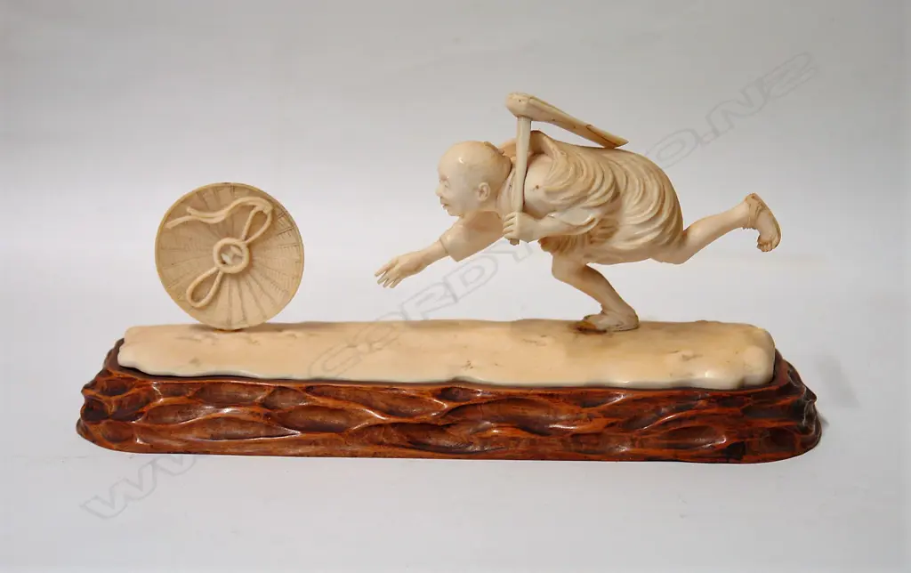 An old Japanese characterful carved ivory figure on stand Image 1++