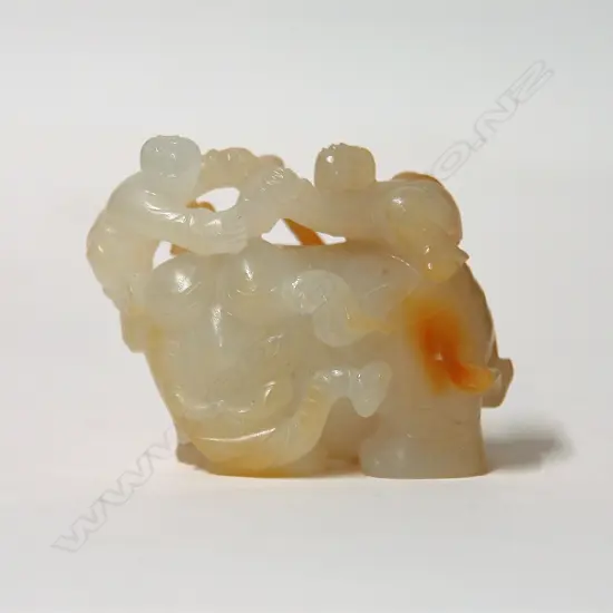 A Chinese Hotan Zi jade carved figure group of an elephant and children