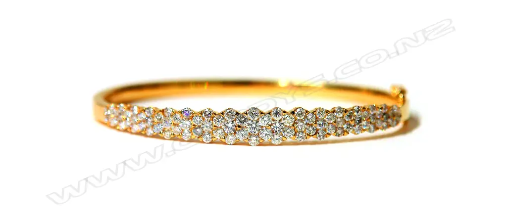 A lady's 18ct. yellow gold and diamond encrusted half-hinged bangle Image 1++